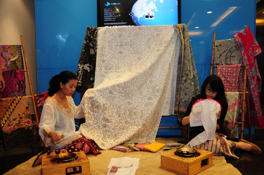 Batik artists demonstrate how to ink on patterned cloth